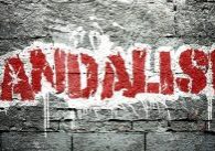 The word "Vandalism" painted on a grey wall